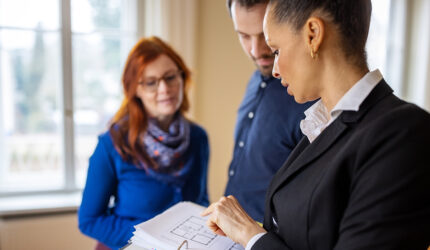 three people reading paperwork